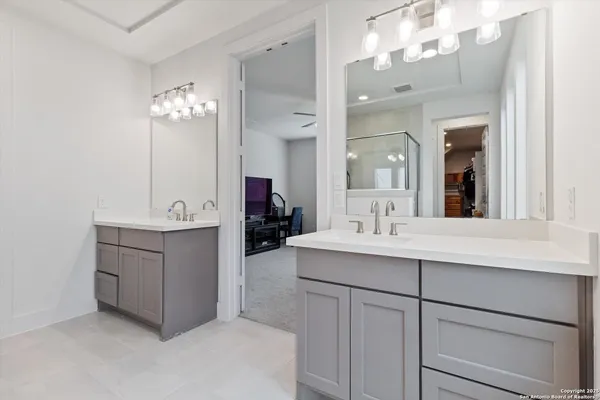 a bathroom with a sink vanity and mirror