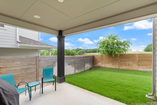 a view of a porch with furniture and a yard