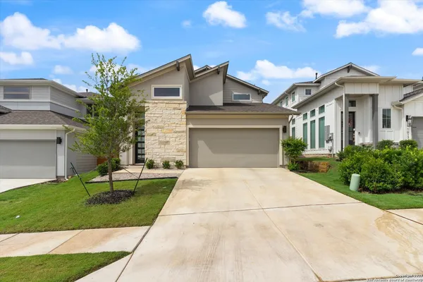 a front view of a house with a yard and a garage