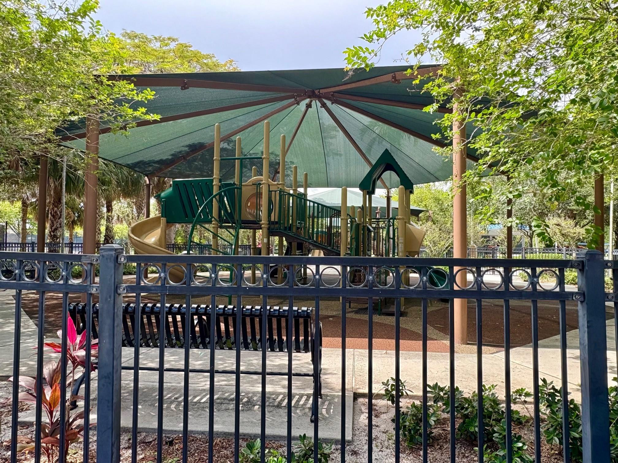 2671 South Course Drive, Unit 108 Pompano Beach, FL 33069 - Photo 29 of 40 a view of patio with a table and chairs under an umbrella
