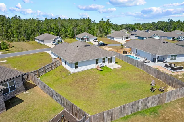 an aerial view of a house with swimming pool