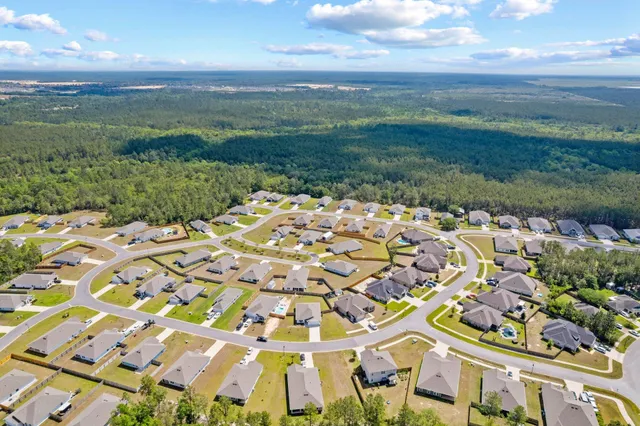 an aerial view of residential house with pool and entrance