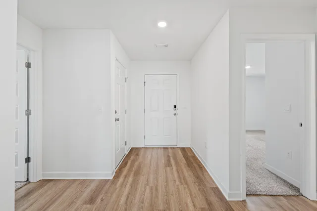 a view of a room with wooden floor