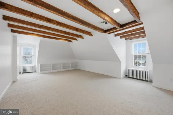 a view of empty room with white walls