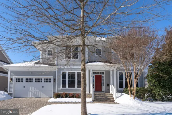 a front view of a house with a tree