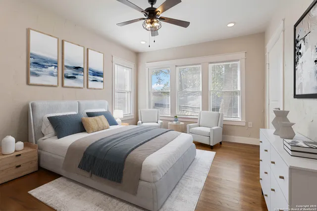 a bedroom with a large bed and a chandelier