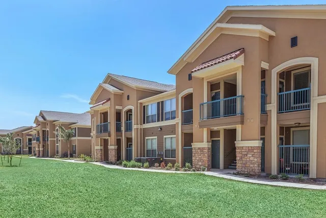 a front view of a building with a yard