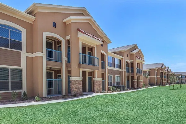 a view of an apartment with a backyard