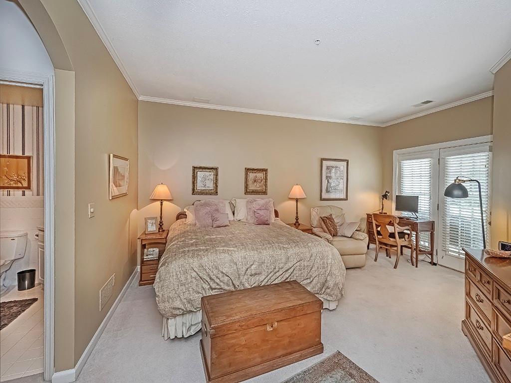 210 Adams Pointe Boulevard, Unit 6 Mars, PA 16046 - Photo 18 of 35 a bedroom with a bed and wooden floor