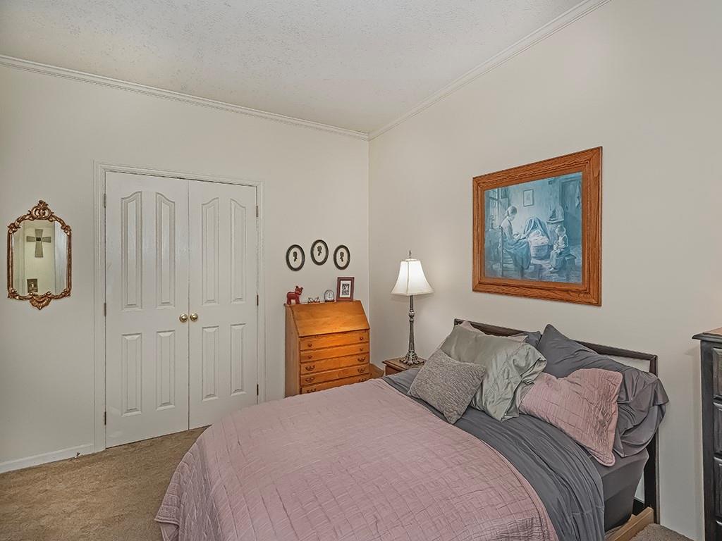 210 Adams Pointe Boulevard, Unit 6 Mars, PA 16046 - Photo 22 of 35 a bedroom with a bed and painting on the wall