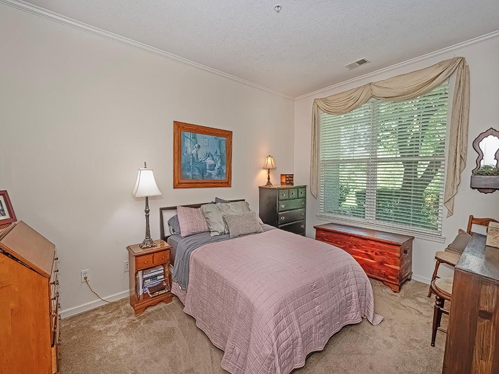 210 Adams Pointe Boulevard, Unit 6 Mars, PA 16046 - Photo 23 of 35 a bedroom with a bed and a large window