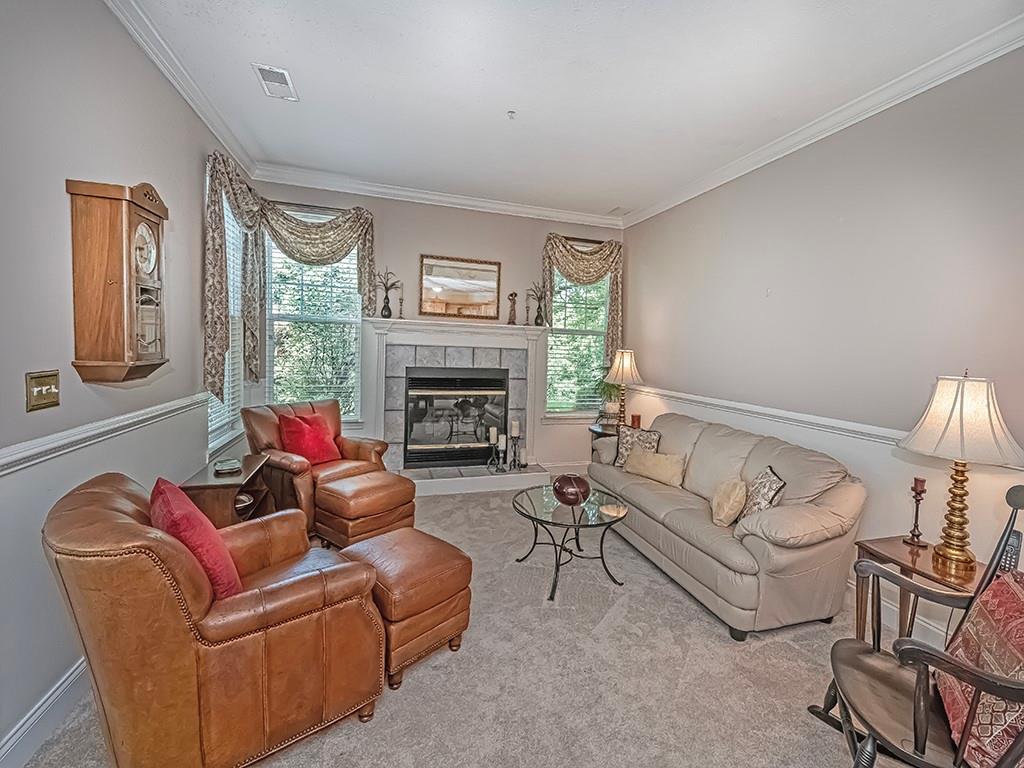 210 Adams Pointe Boulevard, Unit 6 Mars, PA 16046 - Photo 5 of 35 a living room with furniture mirror on the wall and a fireplace