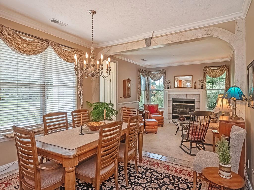 210 Adams Pointe Boulevard, Unit 6 Mars, PA 16046 - Photo 8 of 35 a view of a dining room with furniture wooden floor and chandelier