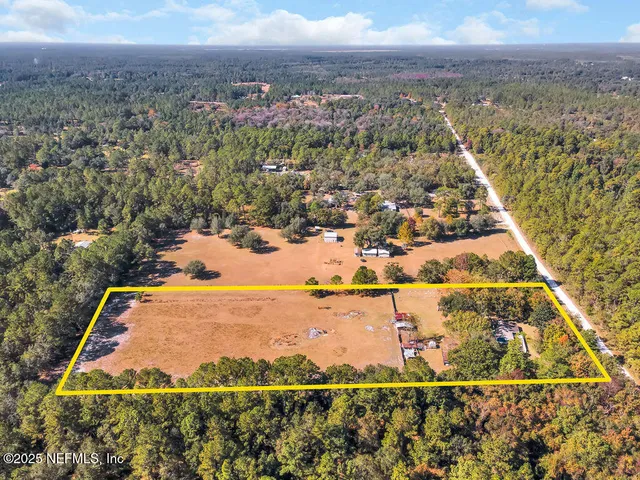 a view of outdoor space with swimming pool and trees in the background