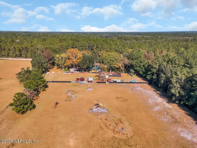 an aerial view of a house with a yard
