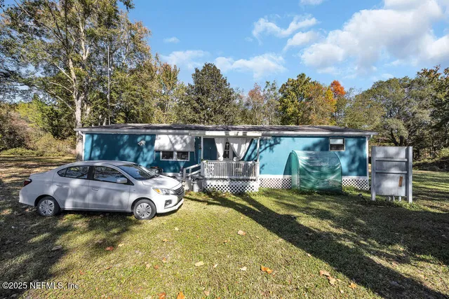 a bedroom with furniture and a wooden floor