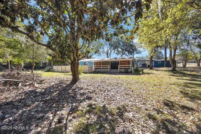 a view of a dining room with furniture and a chandelier
