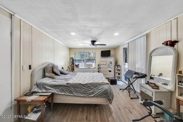 a kitchen with a refrigerator a stove a sink dishwasher and a dining table with wooden floor