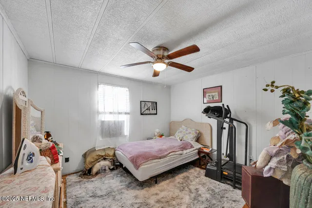 a living room with furniture a rug and a large window