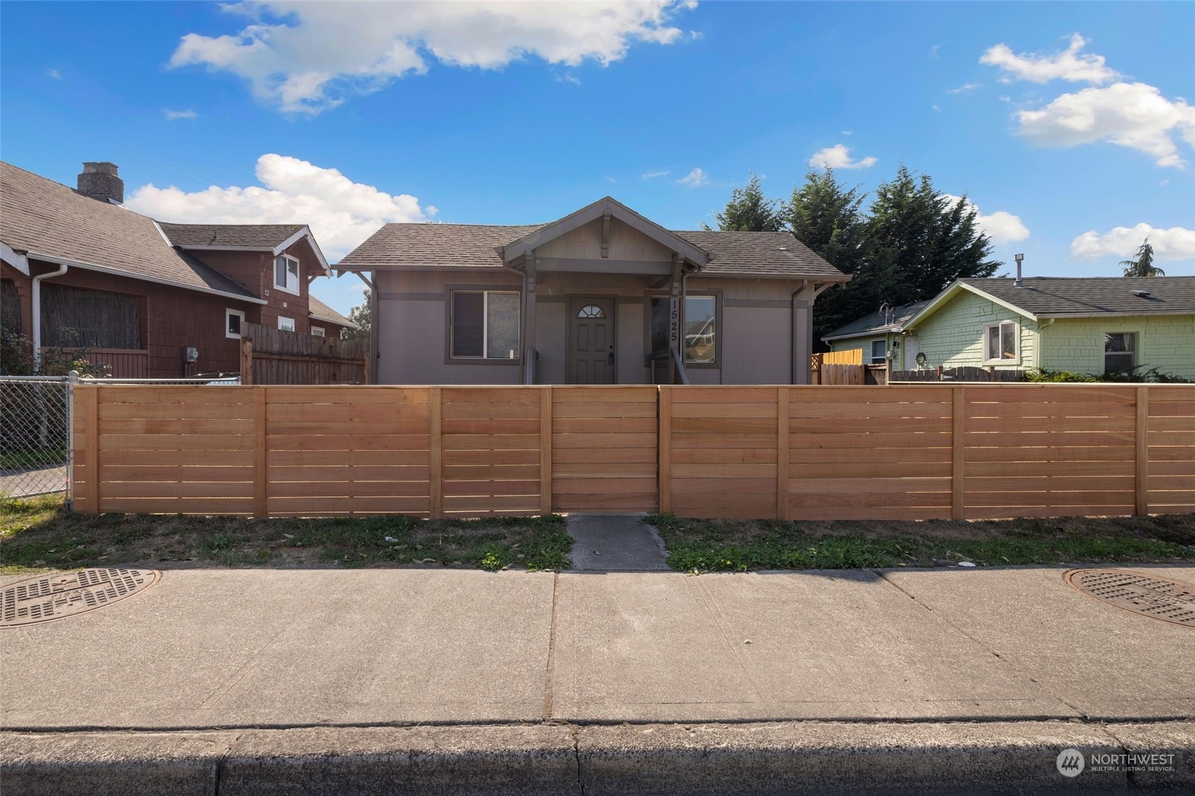 1525 North 3rd Street Renton, WA 98057 - Photo 1 of 38 a front view of a house with a yard and garage