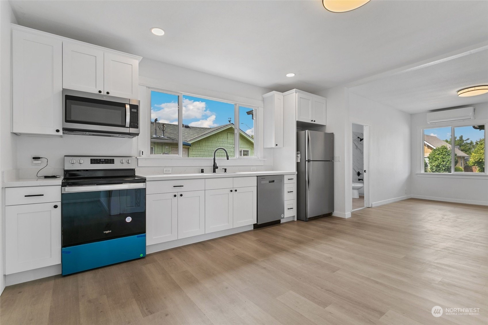 1525 North 3rd Street Renton, WA 98057 - Photo 2 of 38 a kitchen with stainless steel appliances a refrigerator sink and microwave