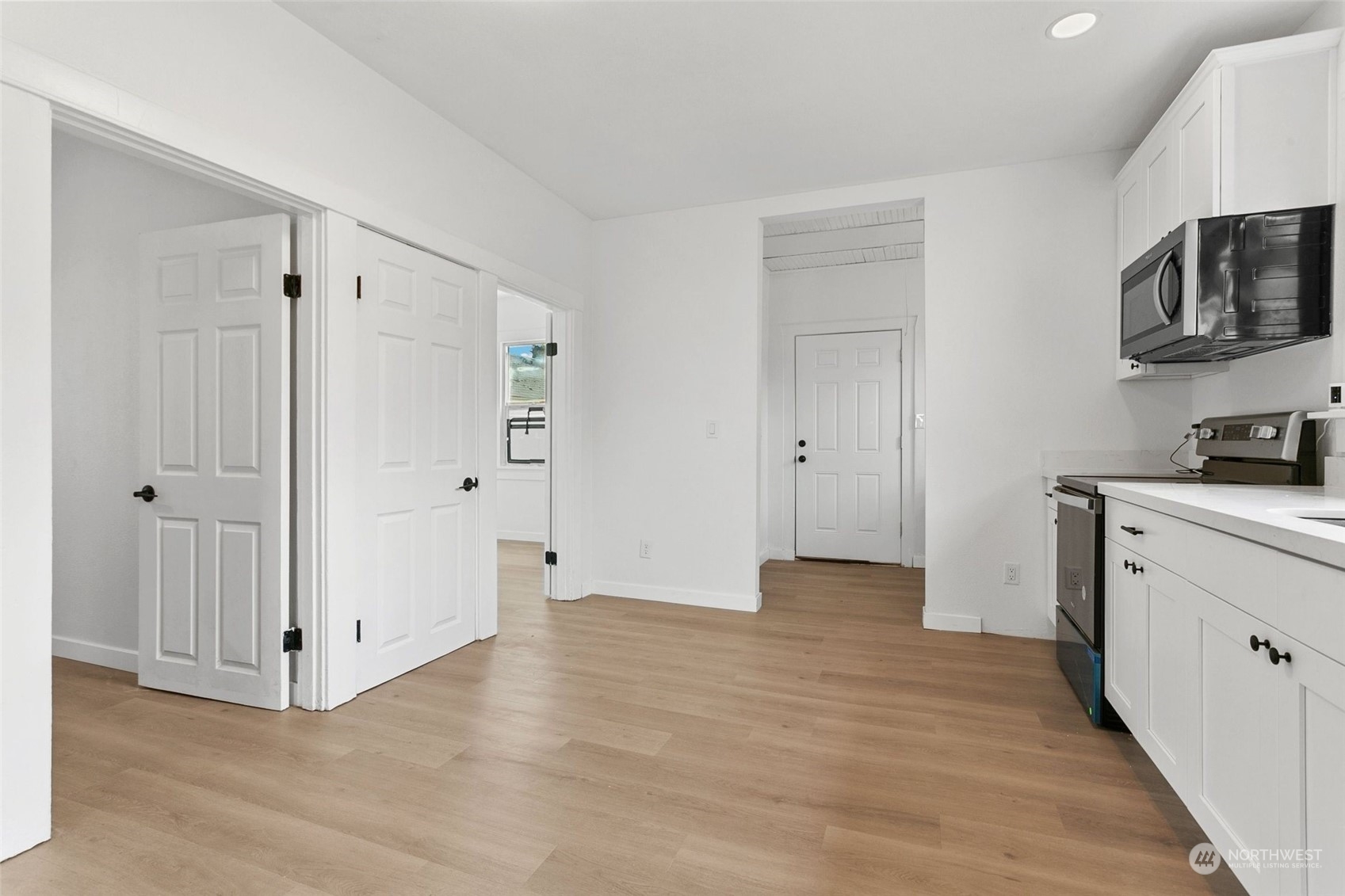 1525 North 3rd Street Renton, WA 98057 - Photo 4 of 38 a view of a kitchen with wooden floor and a sink
