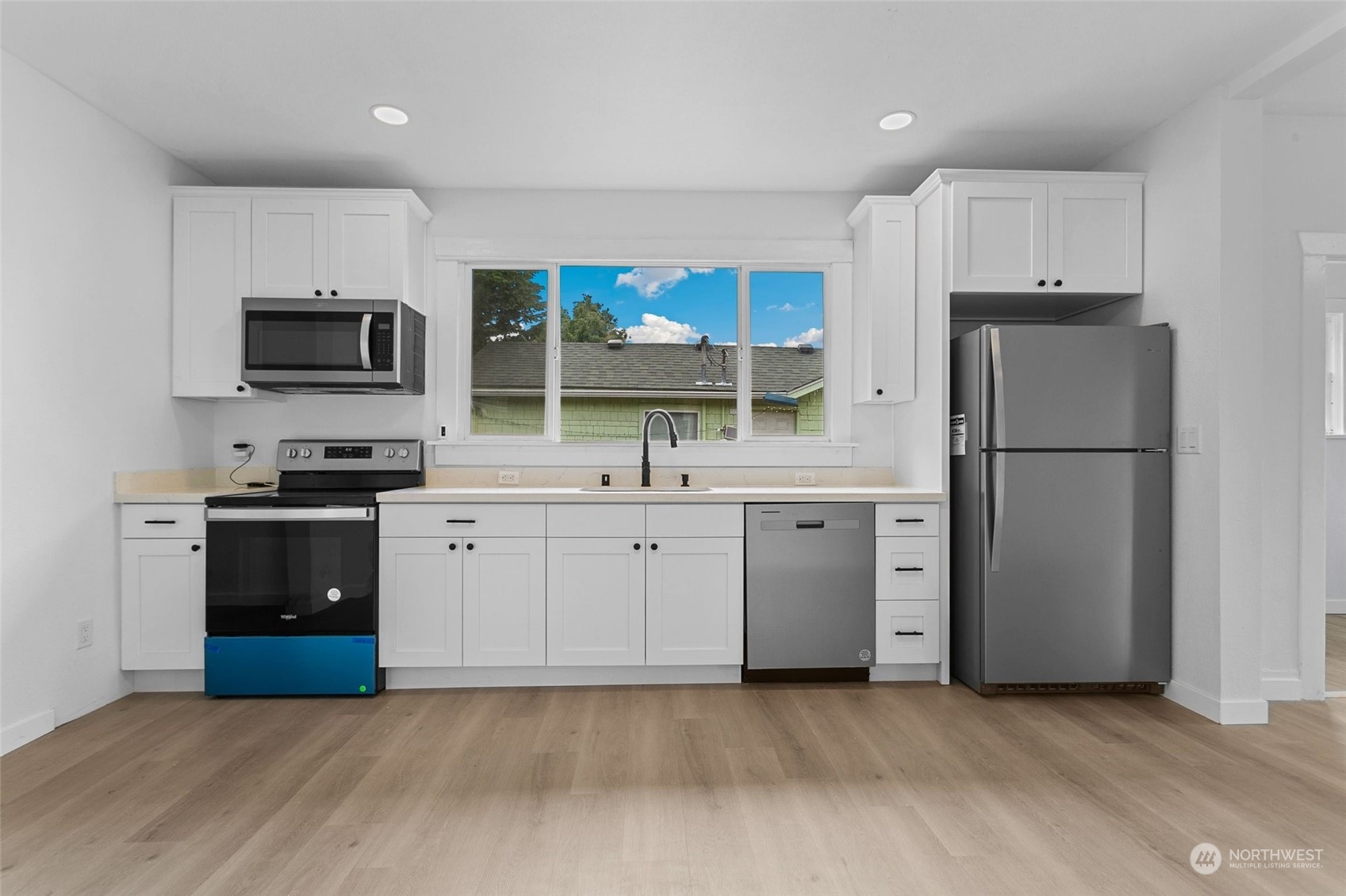 1525 North 3rd Street Renton, WA 98057 - Photo 6 of 38 a kitchen with a refrigerator stove and microwave