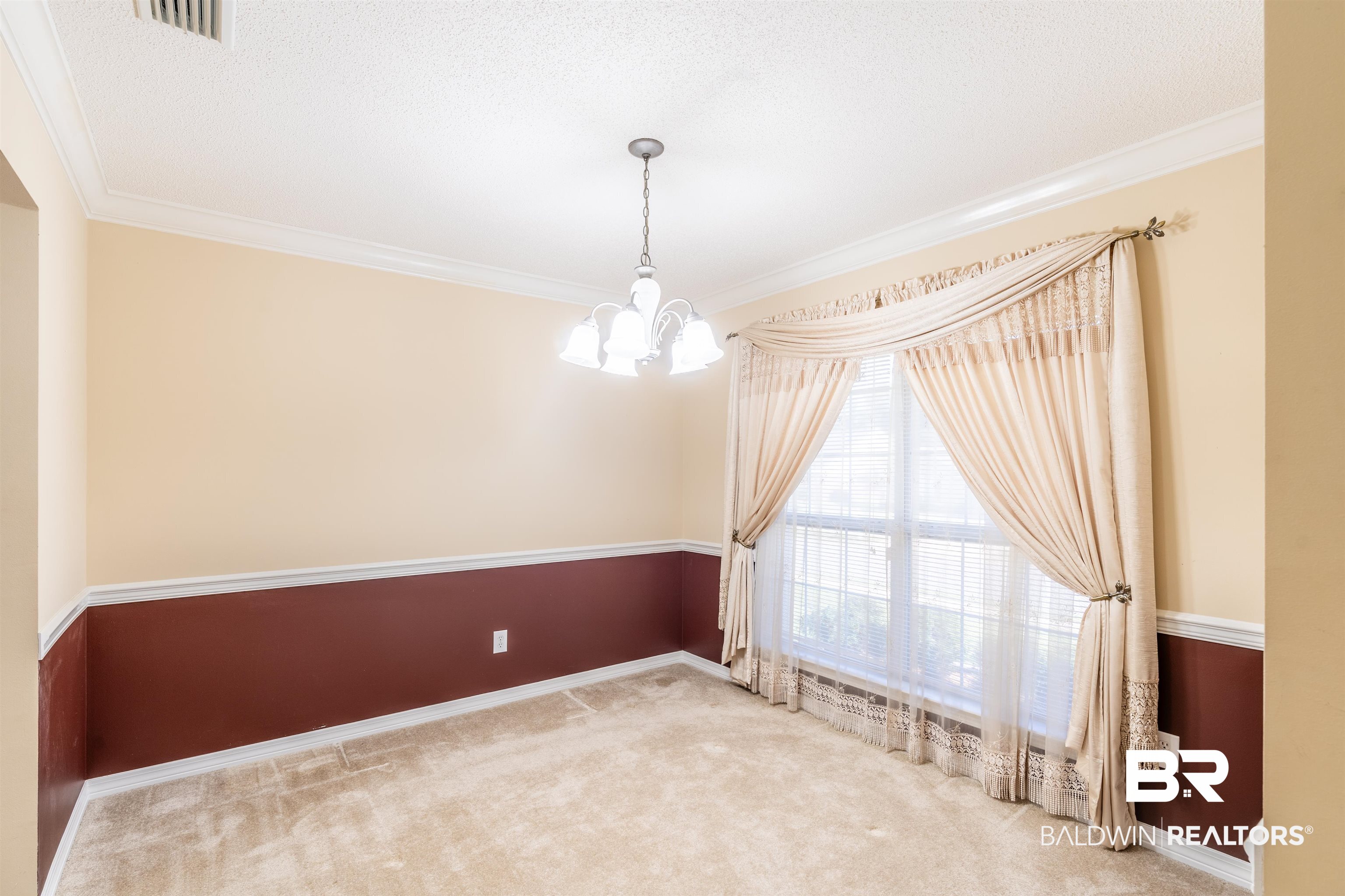 1784 Harrington Way Mobile, AL 36695 - Photo 9 of 18 Carpeted spare room with an inviting chandelier, a textured ceiling, and crown molding