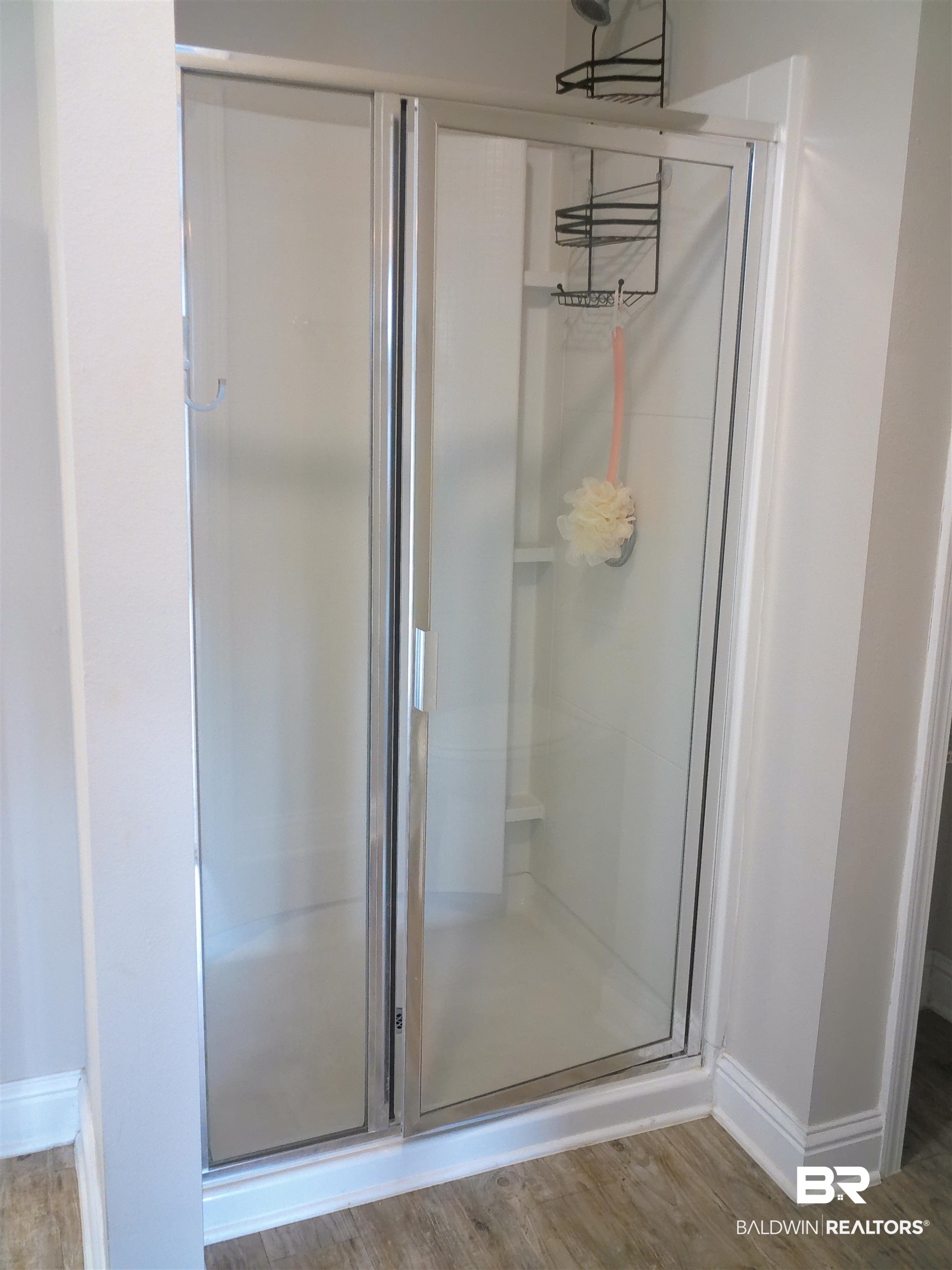 25806 Pollard Road, Unit 23 Daphne, AL 36526 - Photo 6 of 16 Bathroom with a stall shower and wood finished floors