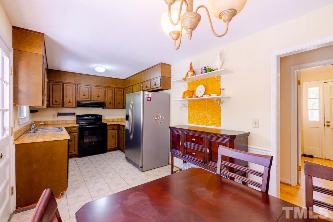 111 Larmack Court Durham, NC 27713 - Photo 11 of 24 a kitchen with stainless steel appliances granite countertop a refrigerator a stove top oven a sink and dishwasher