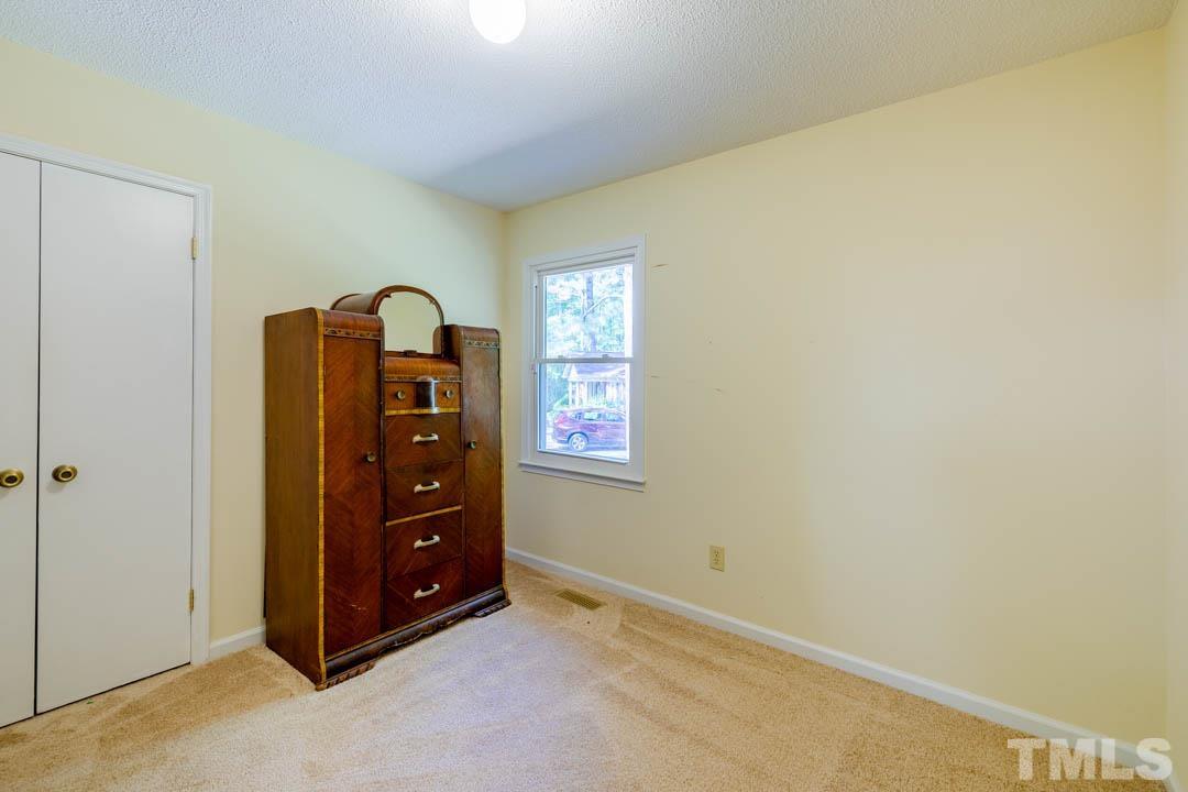 111 Larmack Court Durham, NC 27713 - Photo 15 of 24 a room with a bed and a closet