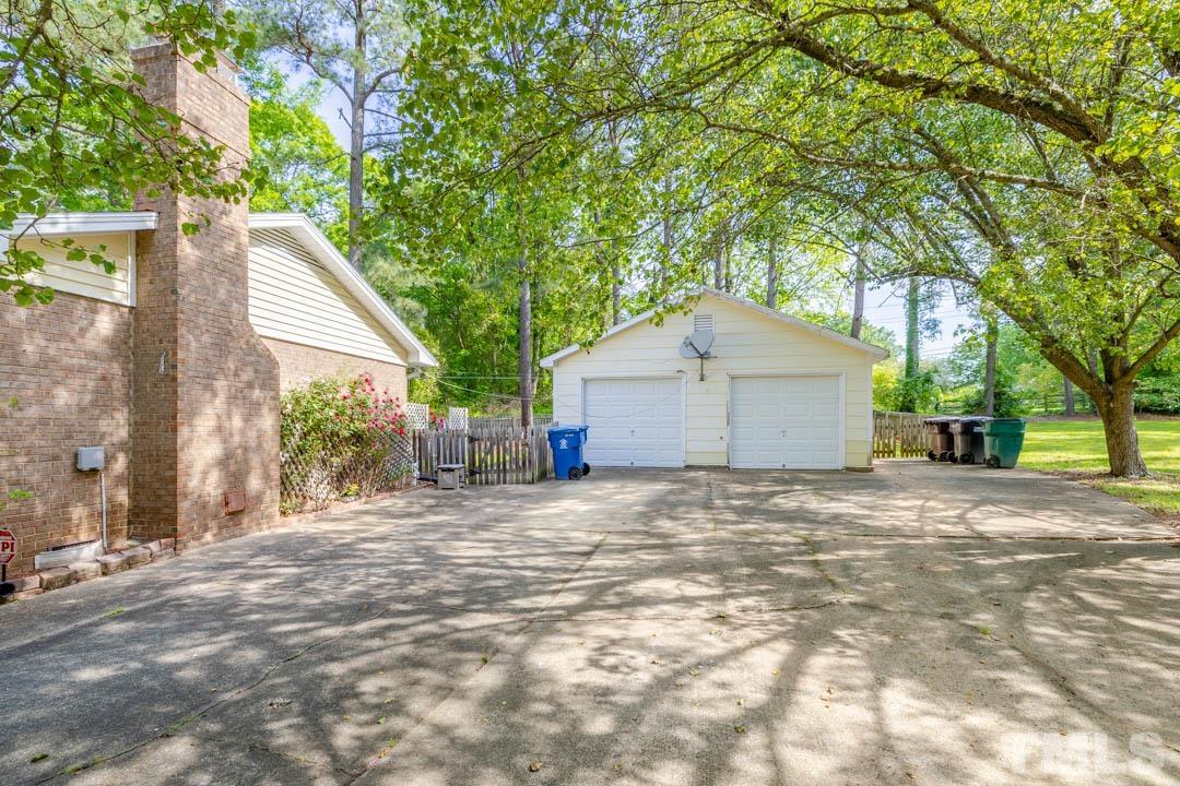 111 Larmack Court Durham, NC 27713 - Photo 3 of 24 a backyard of a house with large trees and outdoor seating