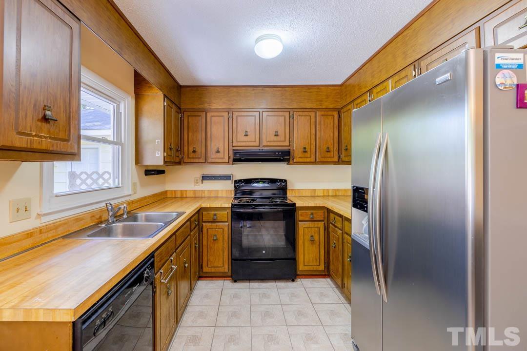 111 Larmack Court Durham, NC 27713 - Photo 5 of 24 a kitchen with a refrigerator sink and stove