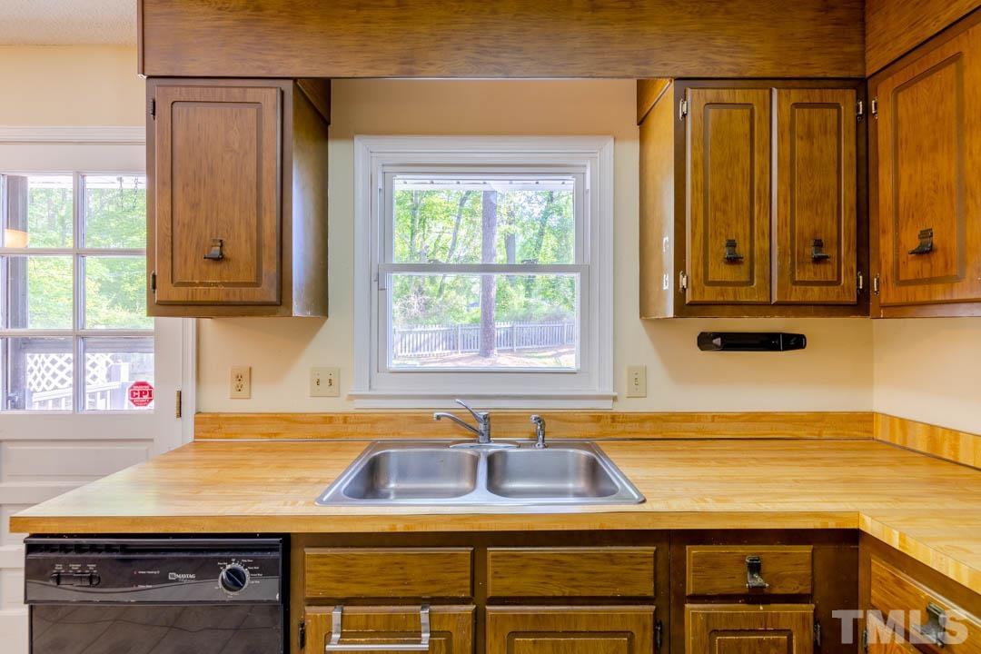 111 Larmack Court Durham, NC 27713 - Photo 7 of 24 a kitchen with a sink cabinets and window