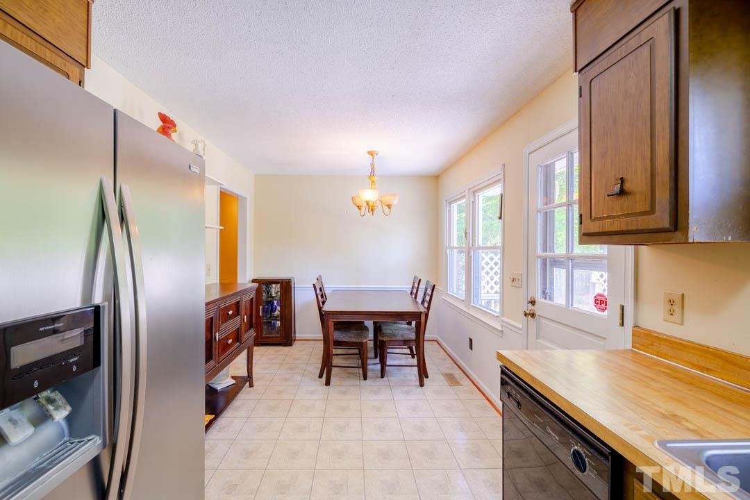 111 Larmack Court Durham, NC 27713 - Photo 8 of 24 a kitchen with stainless steel appliances a sink stove and refrigerator