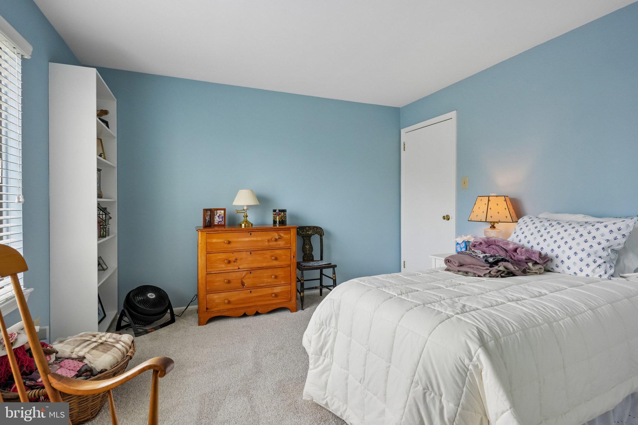 3303A Chadbury Road Mount Laurel, NJ 08054 - Photo 19 of 35 a bedroom with a bed and a lamp on the dresser