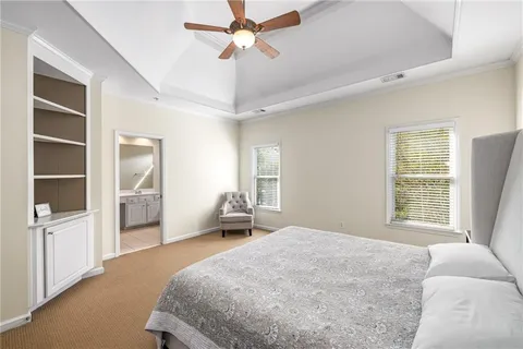 a bedroom with a large bed and a window