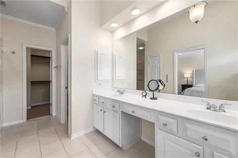 a bathroom with a double vanity sink mirror and next to a window