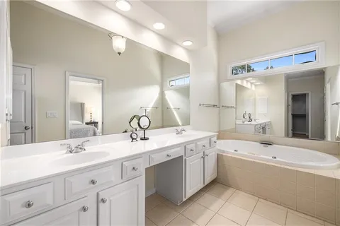 a bathroom with a double vanity sink mirror double and bathtub