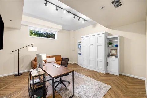 a work room with furniture and a flat screen tv