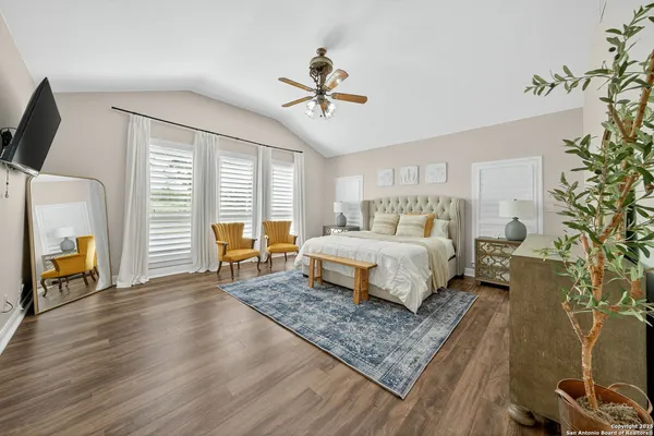 a bedroom with a bed a fireplace and a chandelier