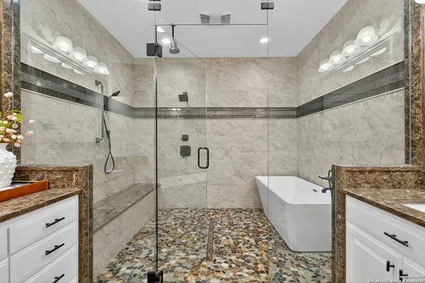 a bathroom with a granite countertop sink a toilet and shower