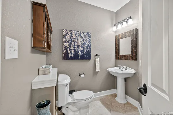 a bathroom with a sink toilet and mirror