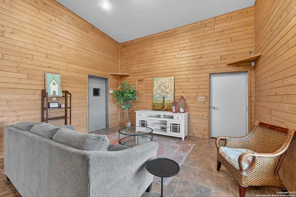 a living room with furniture and a potted plant