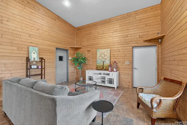 a living room with furniture and a potted plant