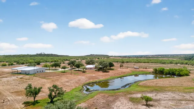 an aerial view of a houses with outdoor space