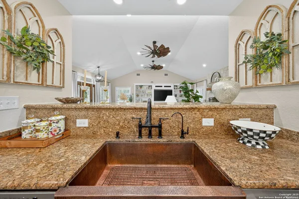 a view of living room with kitchen island granite countertop furniture and floor to ceiling window