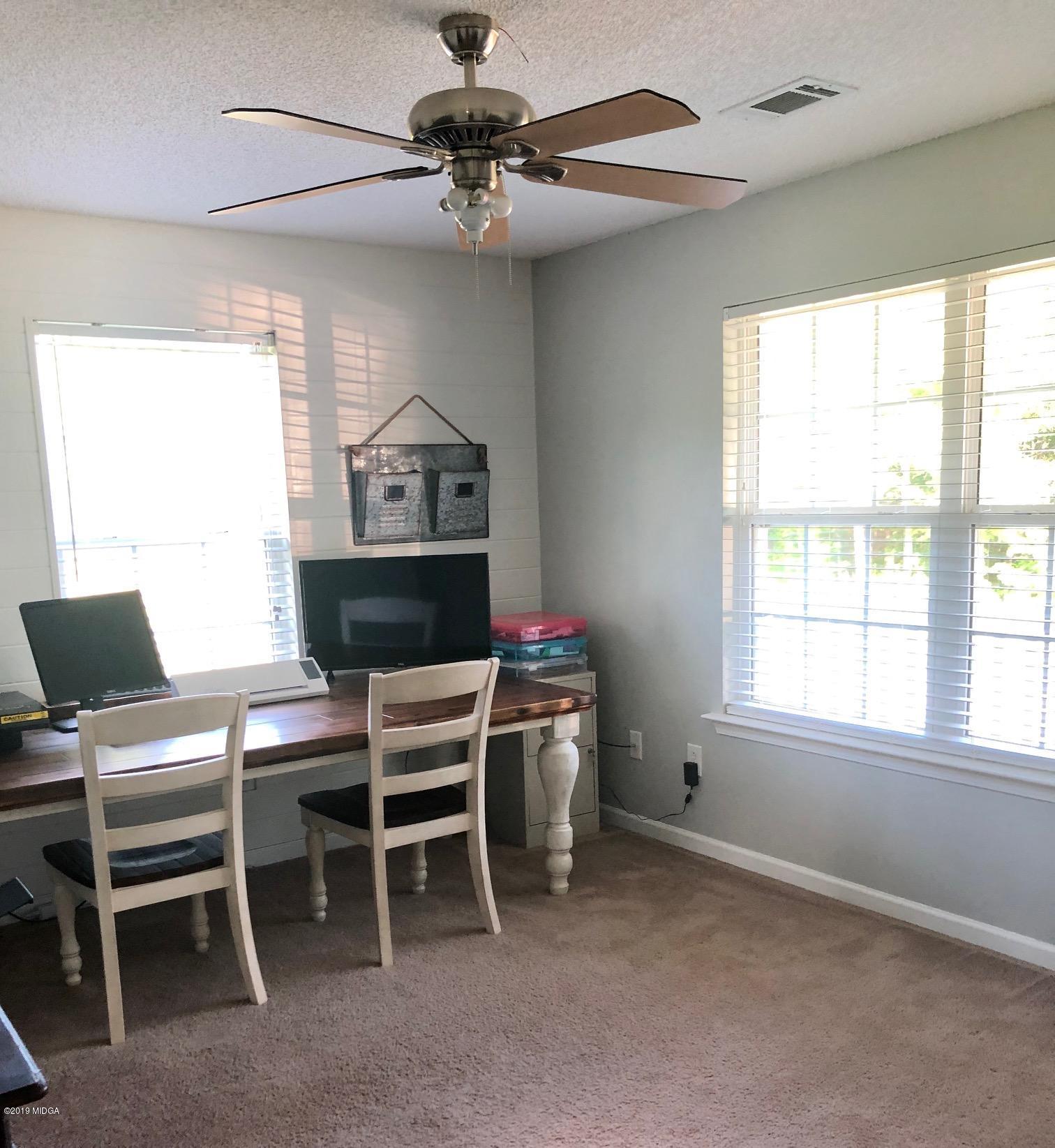 445 Childs Road Roberta, GA 31078 - Photo 13 of 23 a view of a workspace with furniture and a window