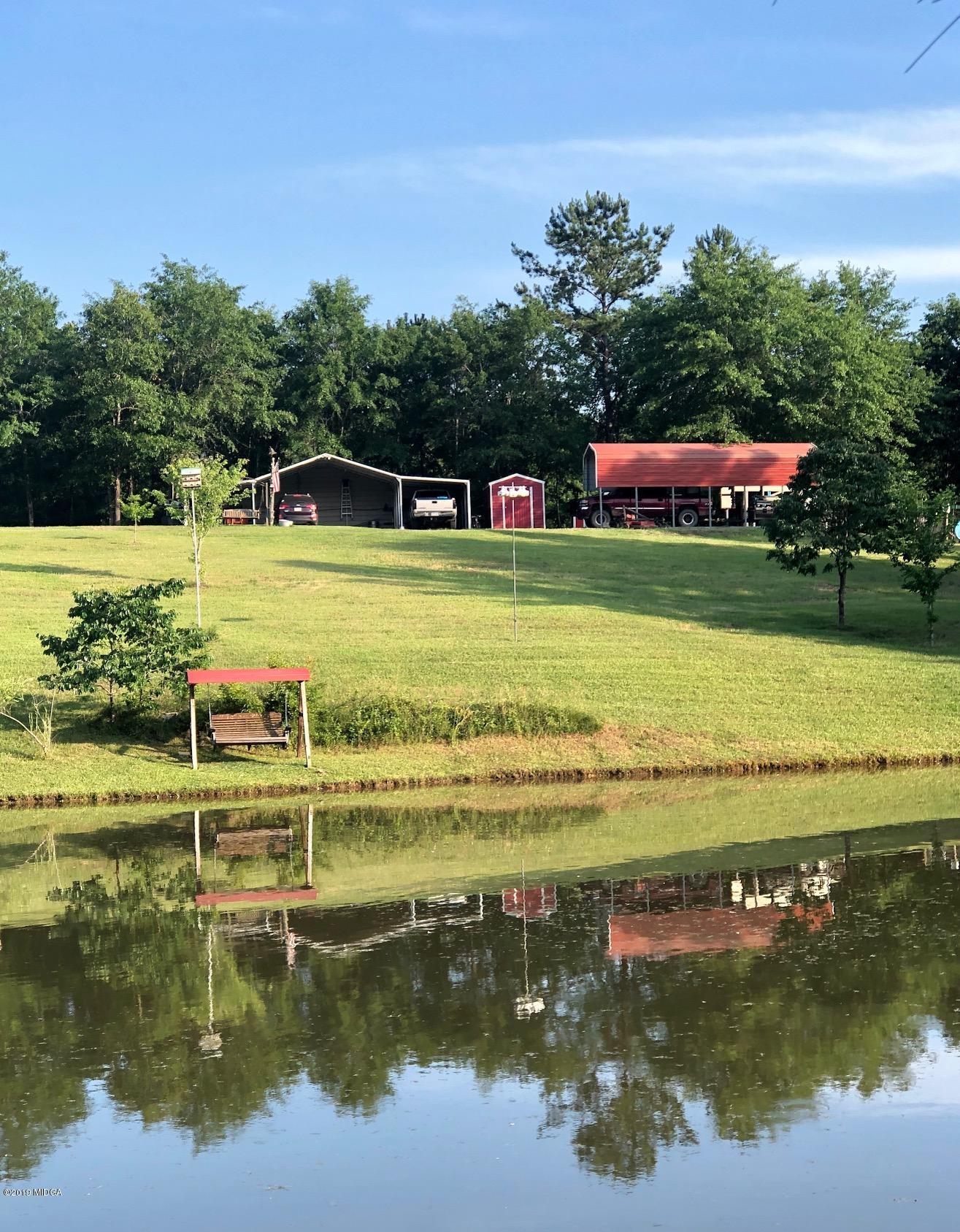 445 Childs Road Roberta, GA 31078 - Photo 17 of 23 a view of a lake with a house in the background