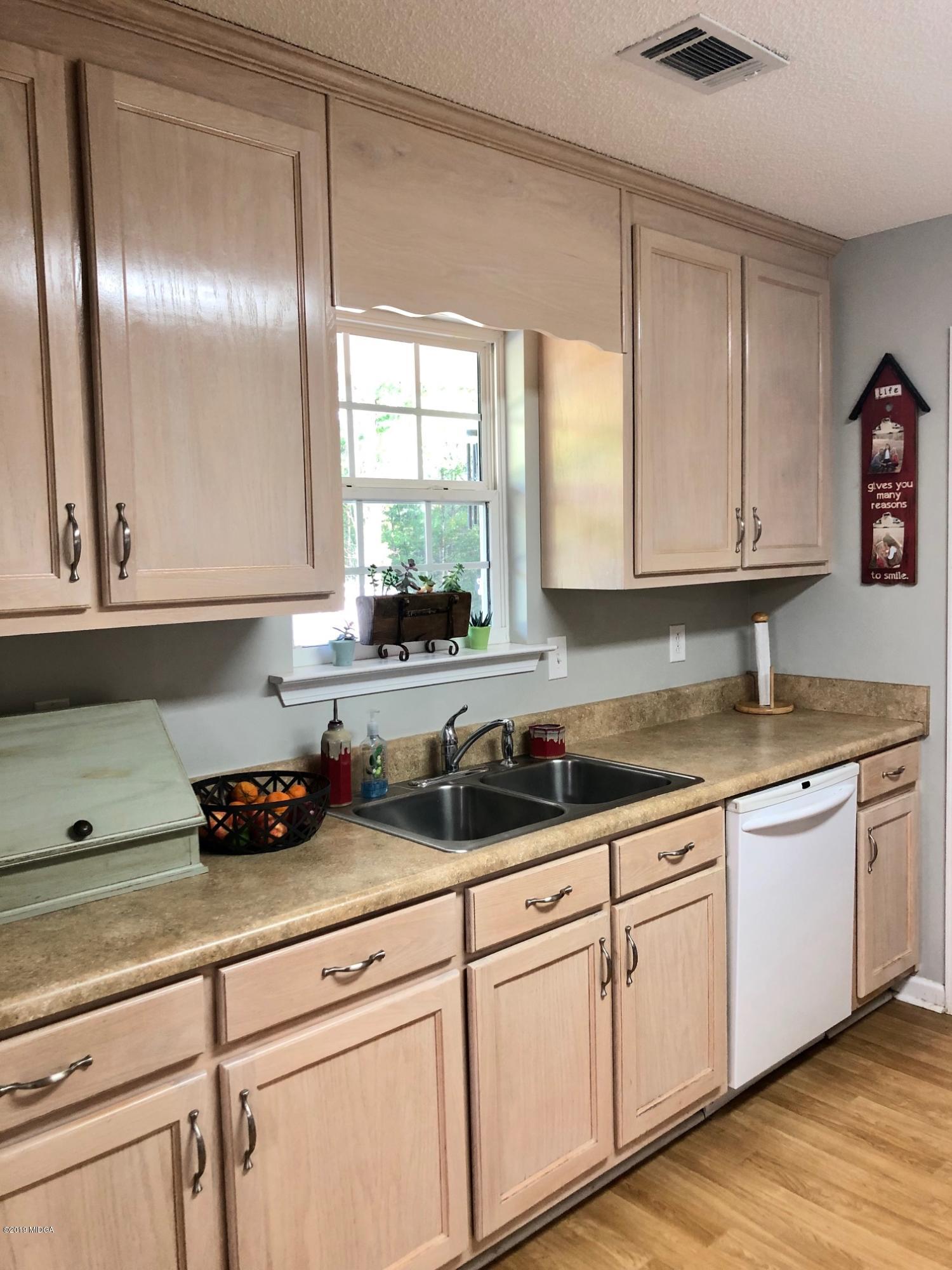 445 Childs Road Roberta, GA 31078 - Photo 4 of 23 a kitchen with a sink and cabinets